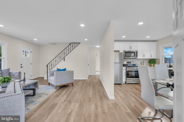 interior space with sink and light hardwood / wood-style flooring