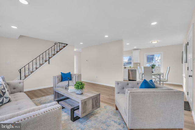 living room featuring light hardwood / wood-style flooring and sink