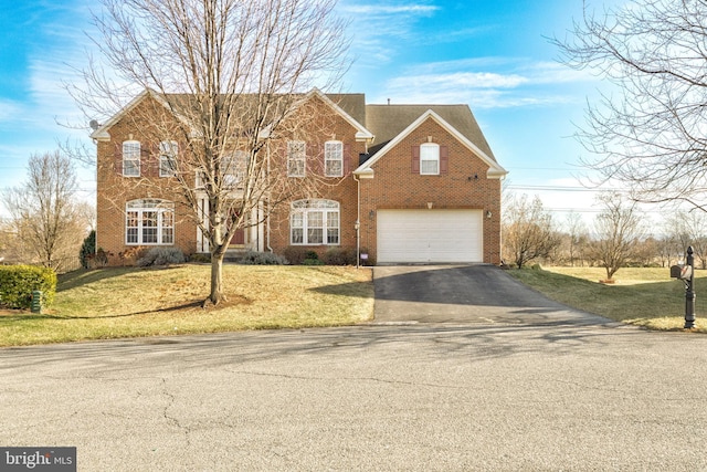 view of property with a garage and a front lawn