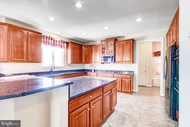 kitchen with dark stone countertops and appliances with stainless steel finishes