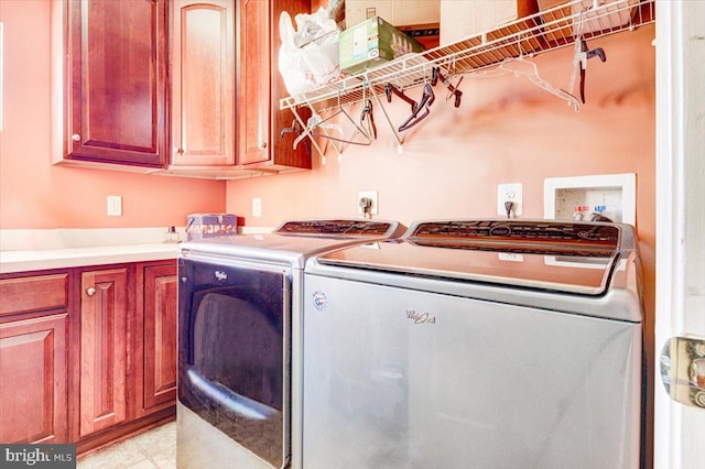 laundry area with washer and dryer and cabinets