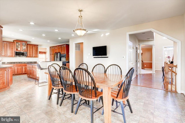 dining room featuring ornate columns