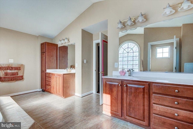 bathroom with vanity and lofted ceiling