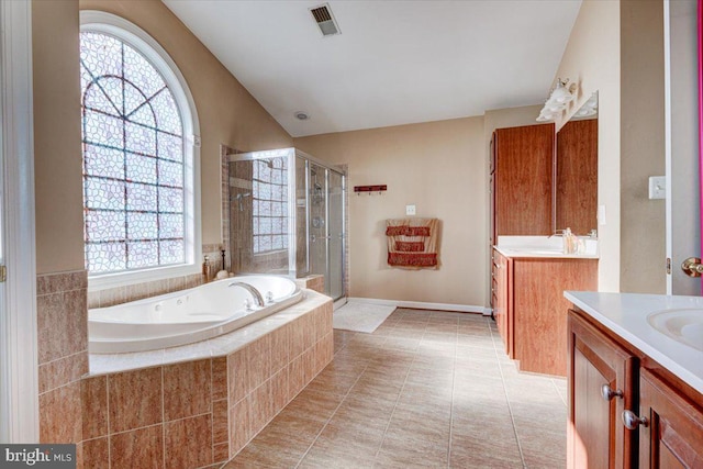 bathroom featuring plus walk in shower, tile patterned flooring, vanity, and vaulted ceiling