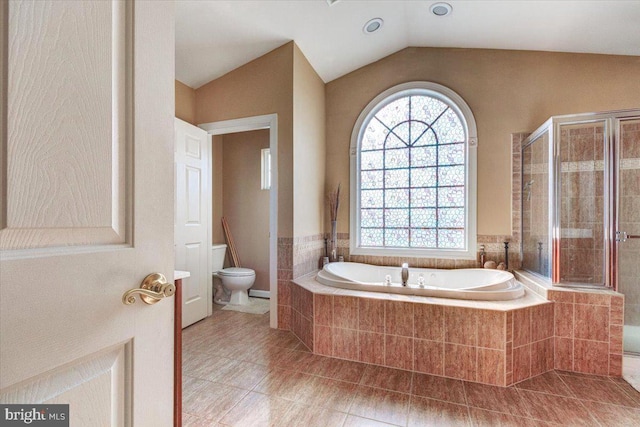 bathroom with tile patterned flooring, independent shower and bath, lofted ceiling, and toilet