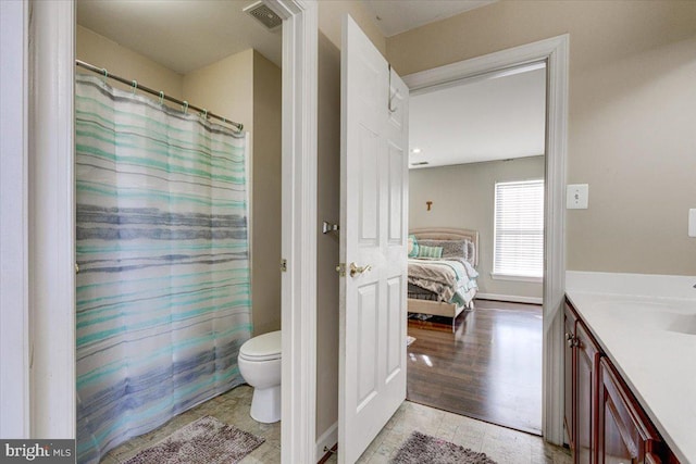 bathroom with vanity, hardwood / wood-style flooring, toilet, and curtained shower