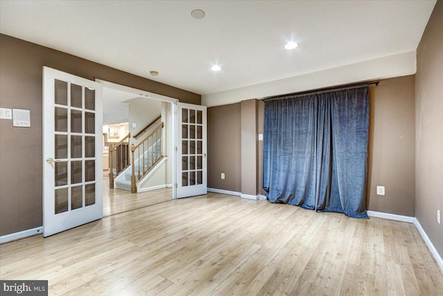 unfurnished room with french doors and light wood-type flooring