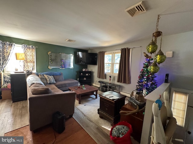 living room with hardwood / wood-style flooring and baseboard heating