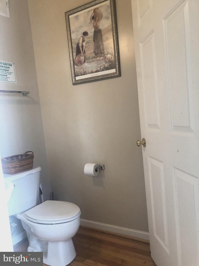 bathroom featuring hardwood / wood-style flooring and toilet