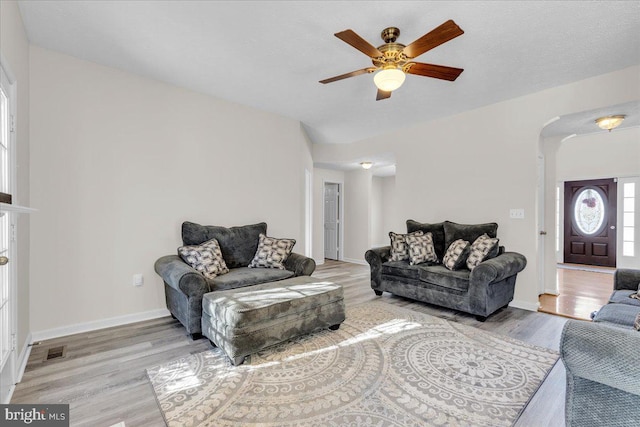 living room with ceiling fan and light wood-type flooring