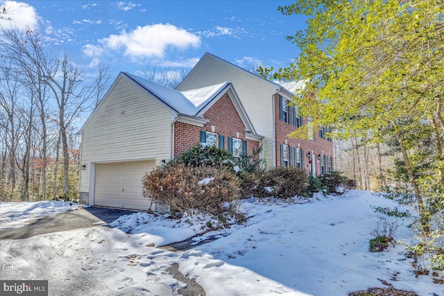 view of snow covered exterior with a garage