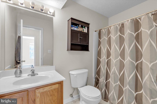 bathroom with a textured ceiling, vanity, toilet, and curtained shower