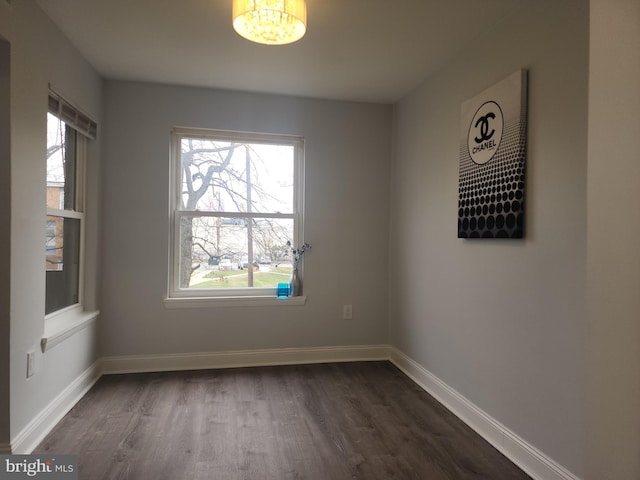 spare room with dark hardwood / wood-style flooring