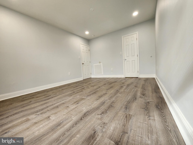 empty room with hardwood / wood-style floors