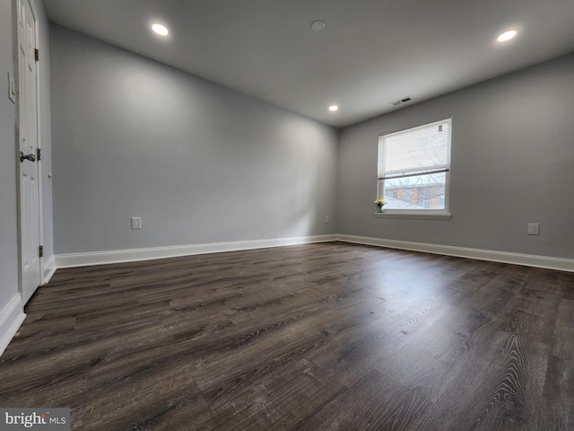 empty room with dark wood-type flooring