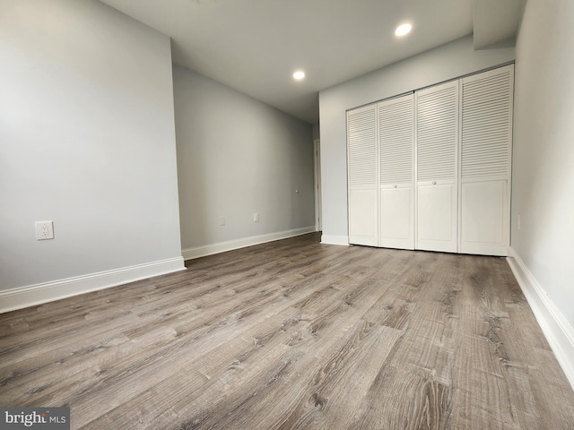 unfurnished bedroom featuring a closet and light wood-type flooring