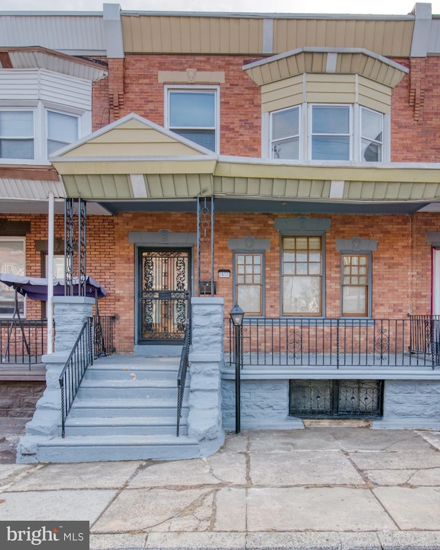 view of exterior entry featuring a porch