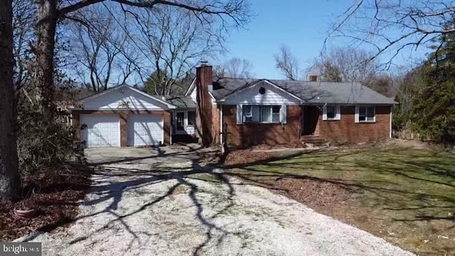 ranch-style home with a front yard and a garage