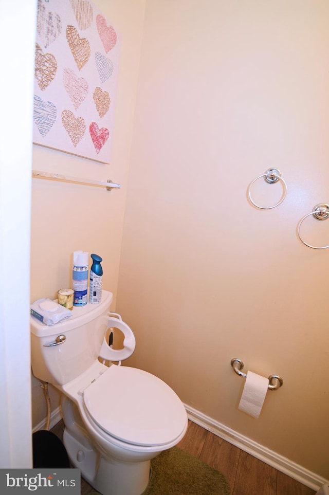 bathroom featuring hardwood / wood-style flooring and toilet