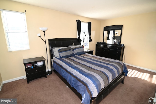 bedroom with dark colored carpet