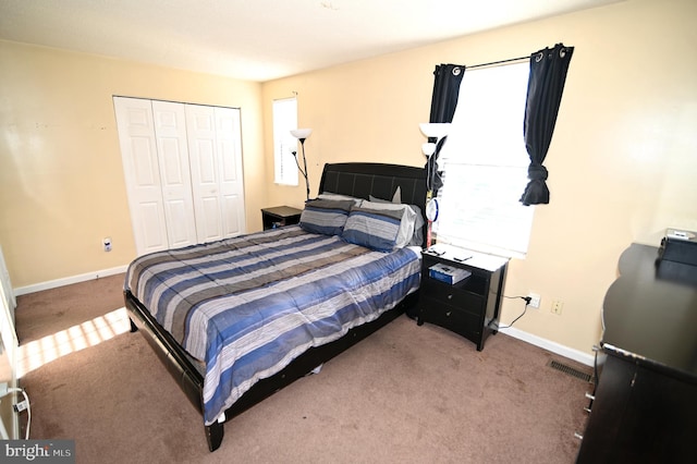 bedroom with carpet floors and a closet