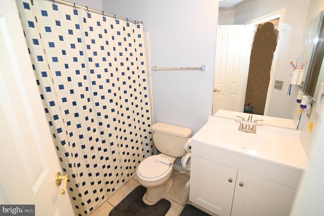 bathroom with toilet, a shower with curtain, vanity, and tile patterned floors