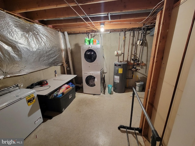 basement with electric water heater and stacked washer and clothes dryer