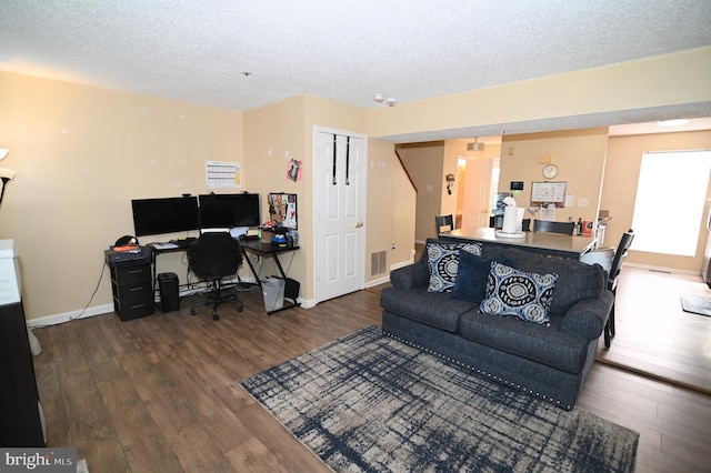 living room with a textured ceiling and hardwood / wood-style flooring