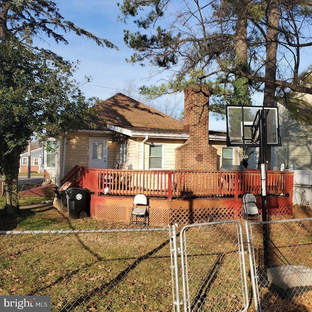 back of house with a yard and a deck