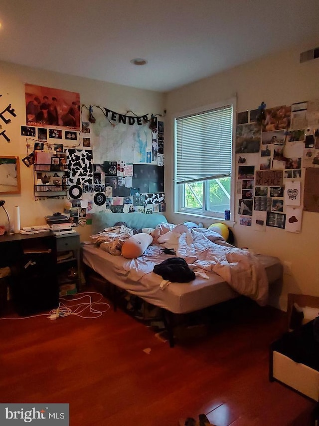 bedroom with hardwood / wood-style floors