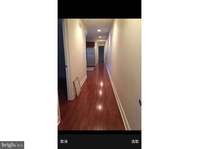 hallway with dark hardwood / wood-style flooring