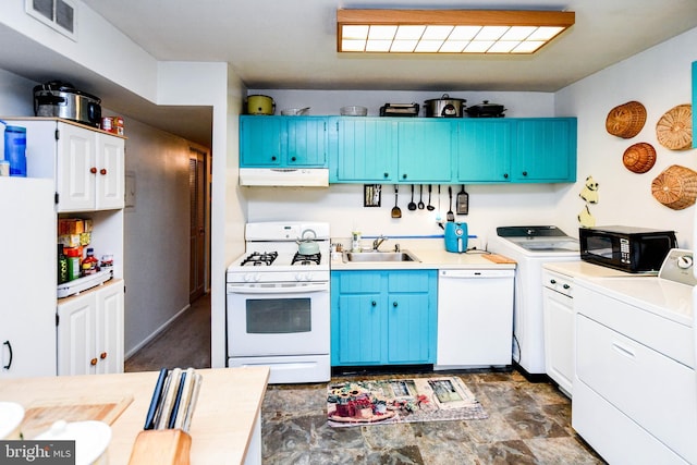 kitchen with sink, white appliances, and blue cabinets