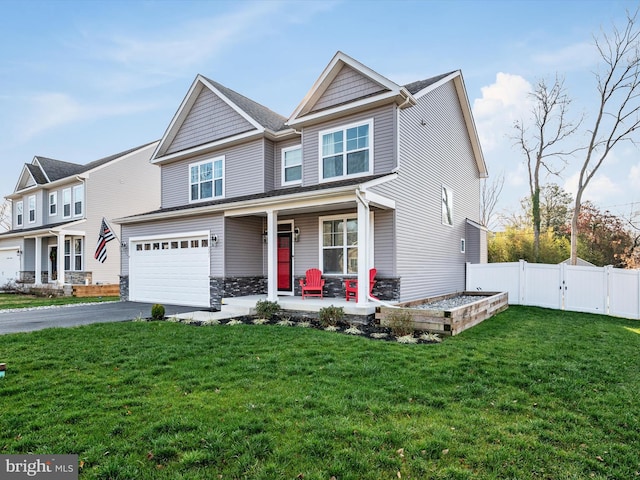 view of front of home featuring a porch, a garage, and a front lawn