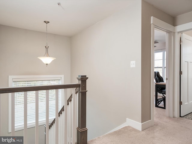 hallway featuring light colored carpet