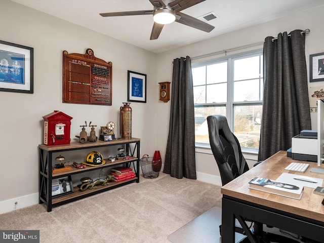 carpeted office space with ceiling fan