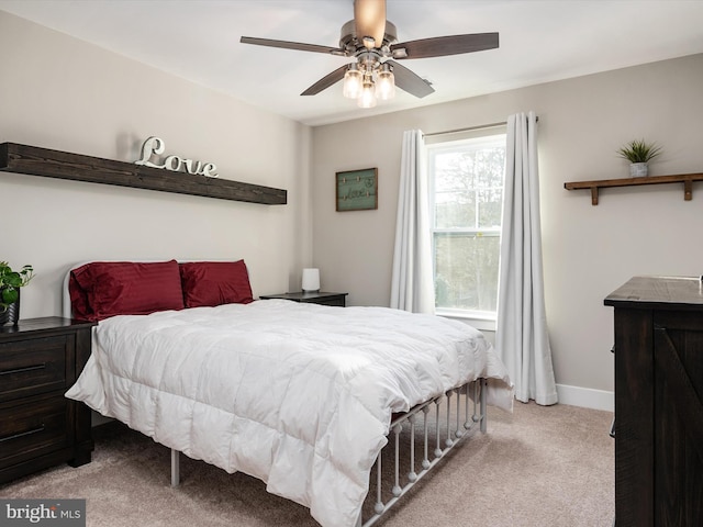 bedroom with light carpet and ceiling fan