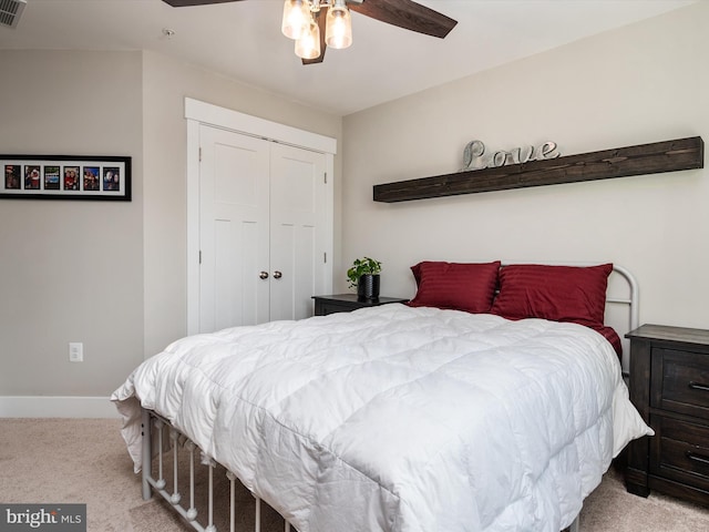 carpeted bedroom featuring a closet and ceiling fan