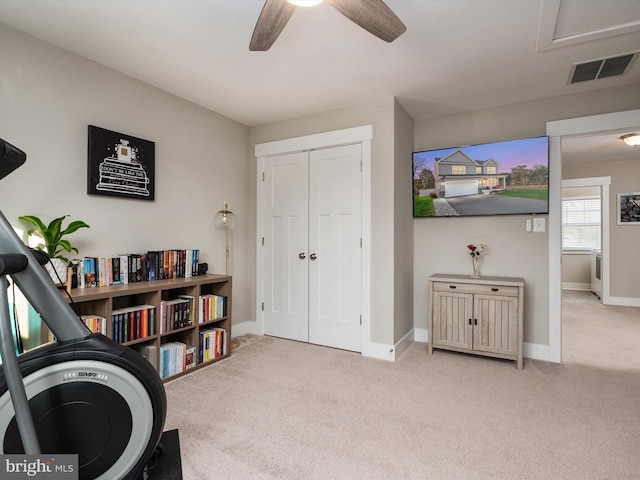 sitting room featuring light carpet and ceiling fan