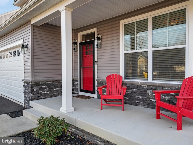 entrance to property with a porch and a garage