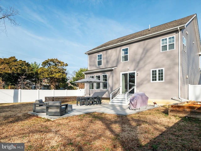 back of property featuring a patio area and a yard