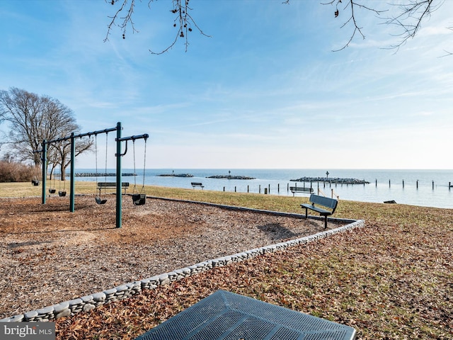 exterior space featuring a water view and a playground