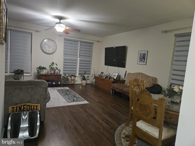 living room with dark hardwood / wood-style floors and ceiling fan