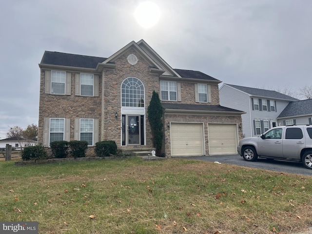 view of front of house with a front lawn and a garage