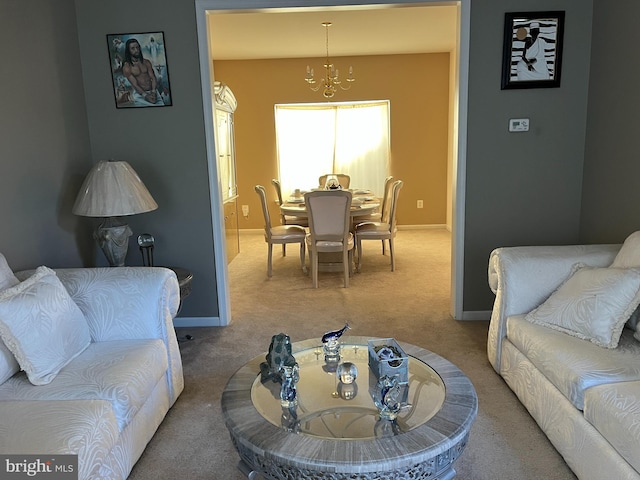 carpeted living room with an inviting chandelier