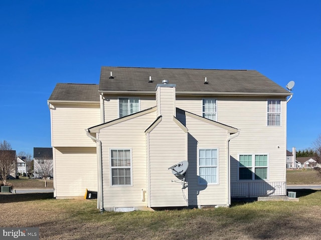 back of property with a lawn