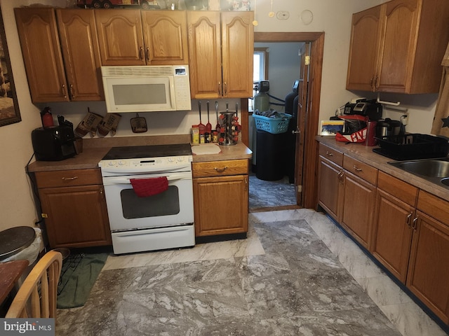 kitchen with white appliances and sink