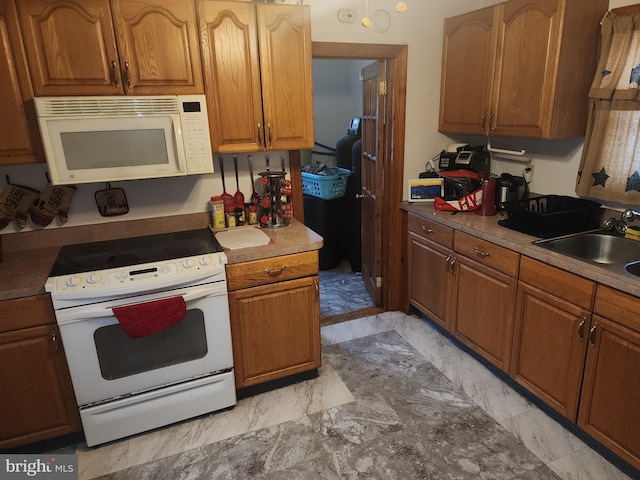 kitchen with sink and white appliances