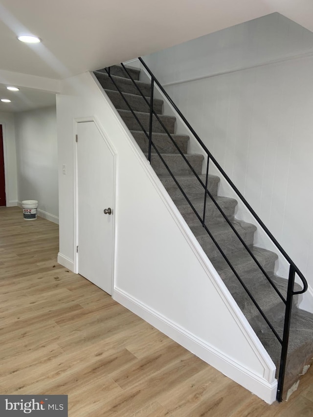 stairs featuring wood-type flooring