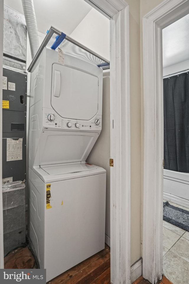 laundry area with stacked washing maching and dryer