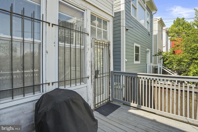 wooden deck with a grill